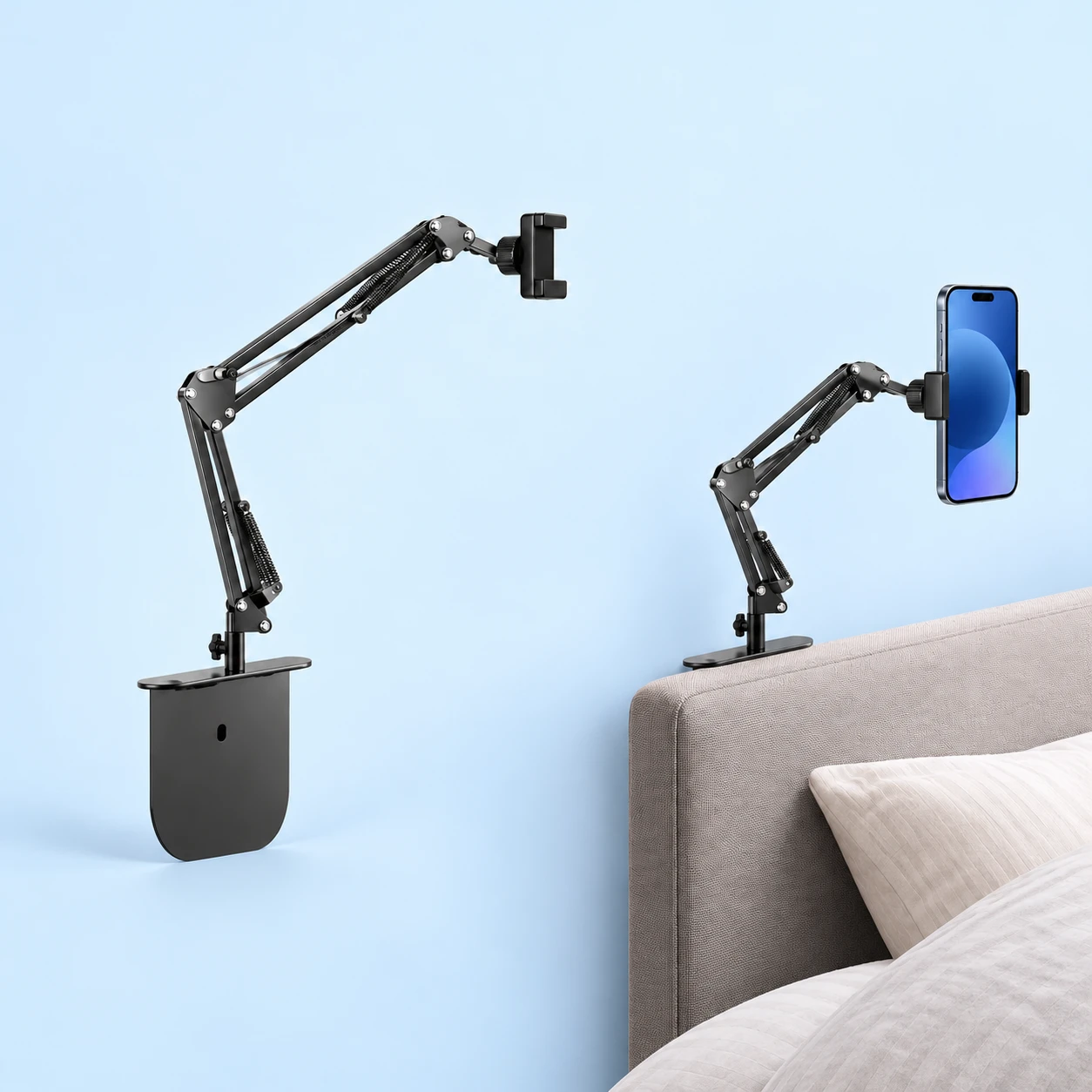 Black gap-base articulated spring-arm phone holder on pale blue, shown complete and empty at left and holding a portrait phone beside an upholstered headboard at right., square composition
