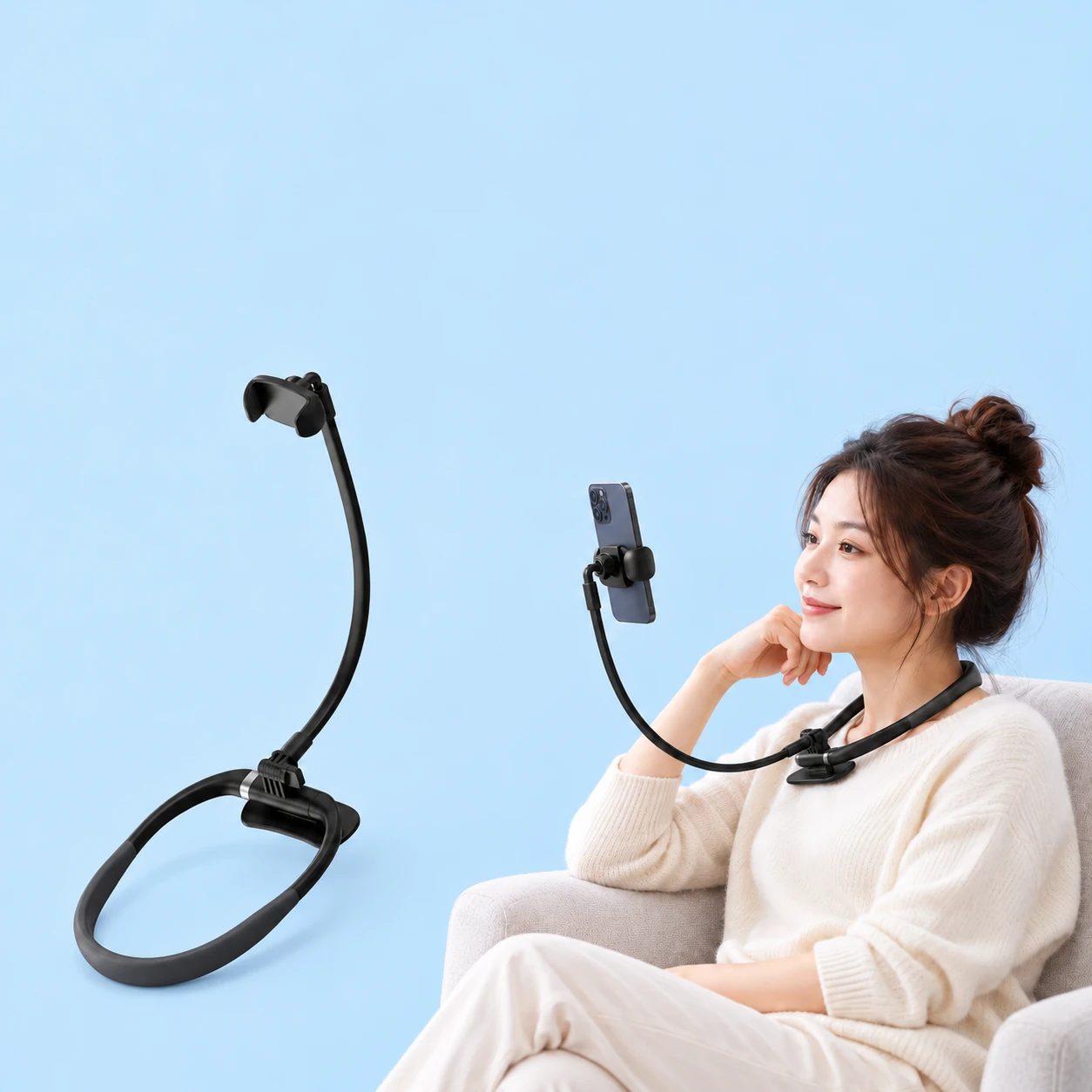 Complete black neck phone holder with closed oval ring, front support foot, one curved arm and rounded phone jaws at left; the same original holder worn by a seated adult and supporting a portrait phone at right, on pale blue., square composition