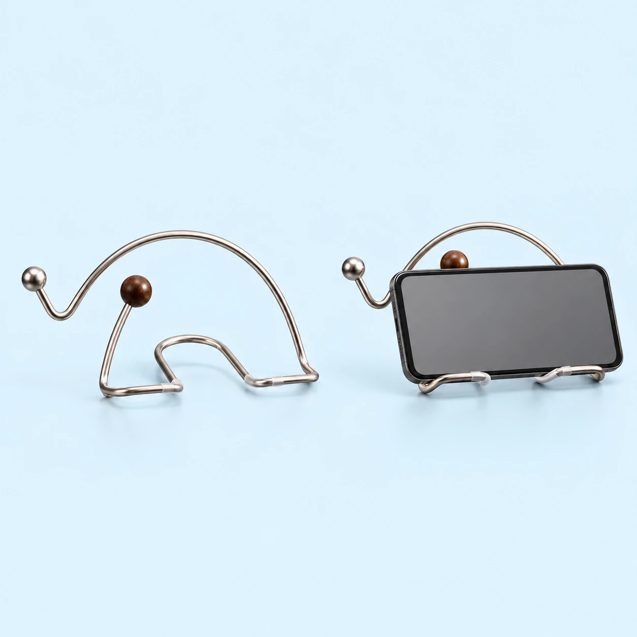Silver wire elephant desktop stand with brown ball accent and landscape phone support illustration, square composition