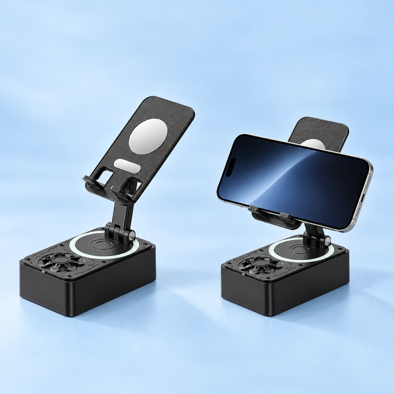 Complete black power-bank and speaker phone stand at left, and the same original twin-hook support holding a landscape demonstration phone at right, on a pale-blue background. Phone not included., square composition