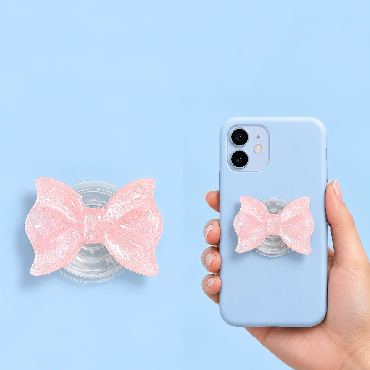 Pastel pink pearlescent molded bow phone grip on a plain clear circular base with closed phone-back placement, square composition