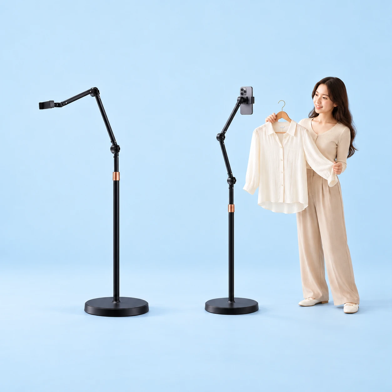 Complete black round-base hinged floor phone stand with copper-colored shaft collar on the left; the same stand holds a portrait smartphone for an adult presenting a shirt on the right, against a pale-blue background., square composition