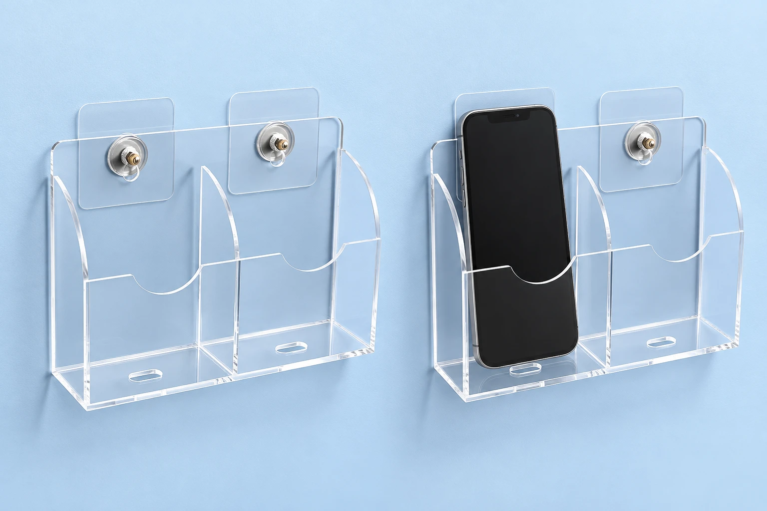 Complete clear two-bay wall phone pocket with its two mounting pads and threaded fittings on the left, and the same holder storing one upright phone in its left bay on the right, against pale blue. Phone shown for context only.