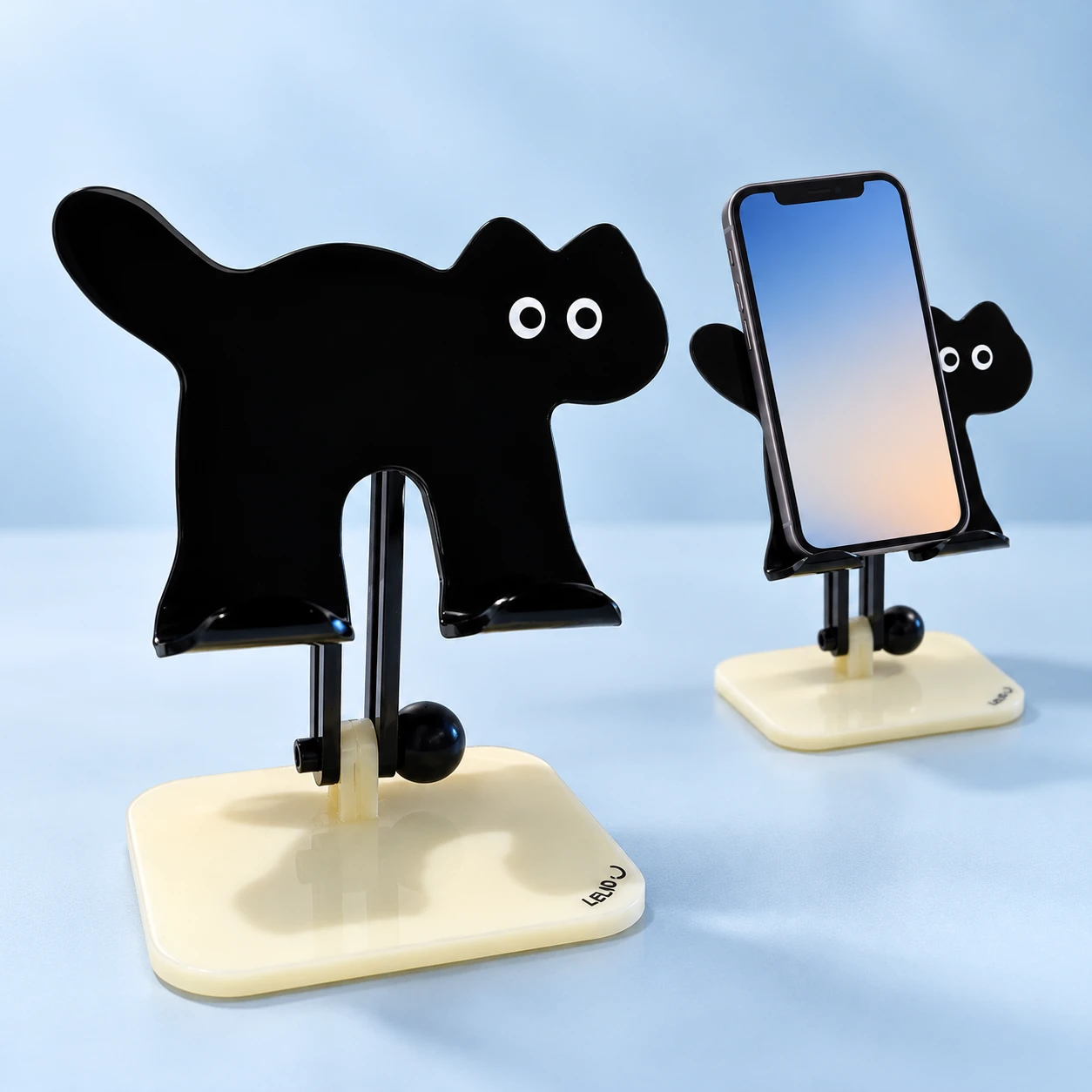 Black Cat Silhouette Adjustable Phone Stand on a pale-blue background, product left and actual use right