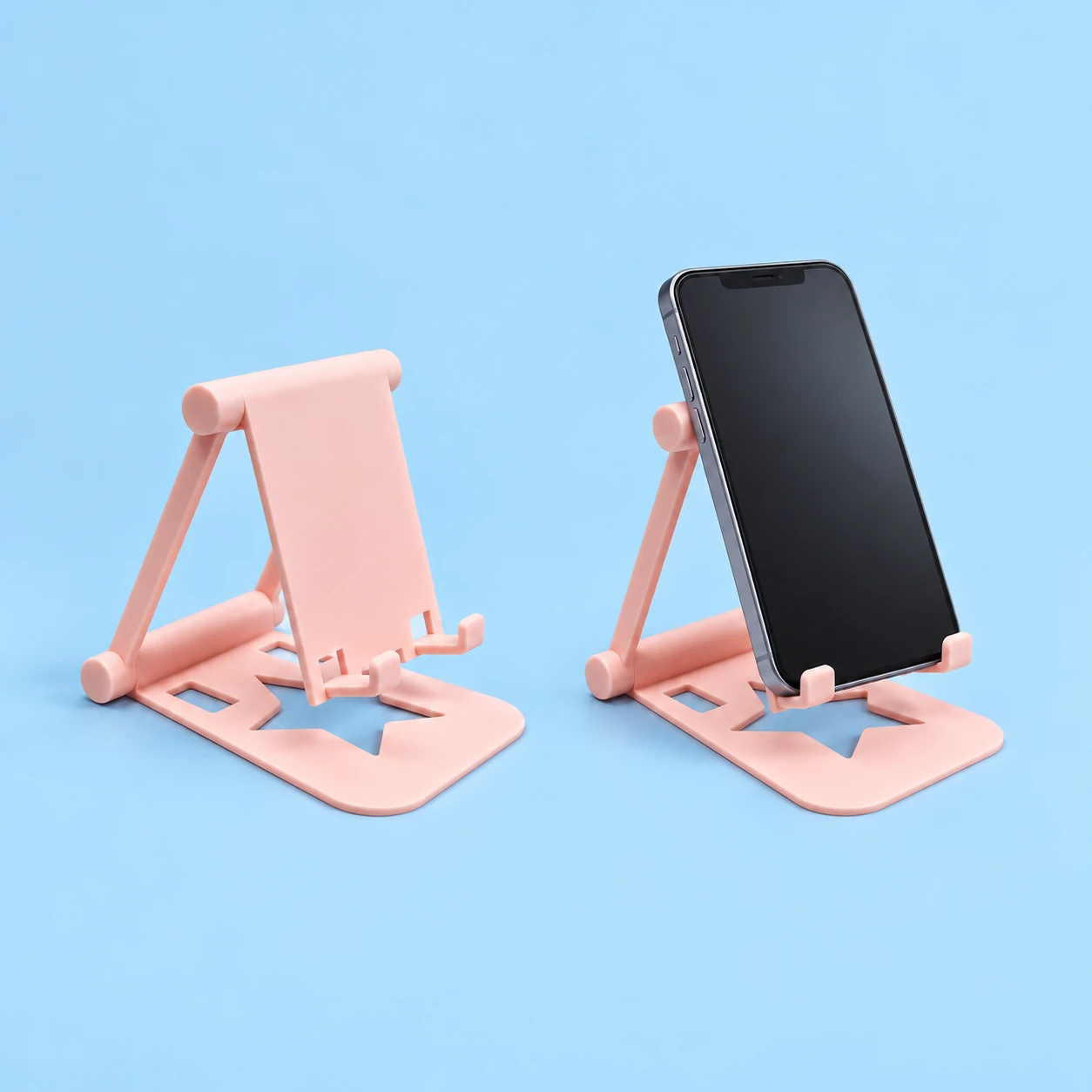 Pastel pink mini folding phone stand with star-cutout base and illustrative supported portrait phone, square composition
