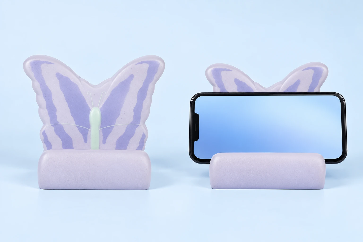 Lilac and cream molded foam butterfly phone cradle with pale mint center, shown empty and in an intended landscape-phone illustration