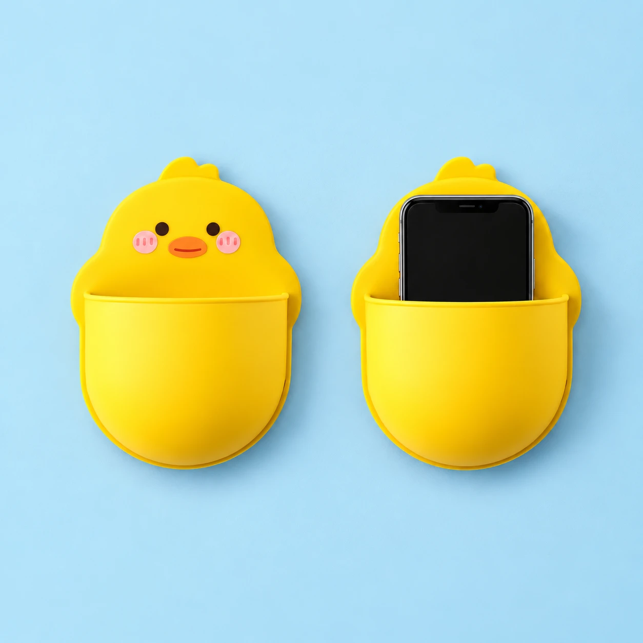 Yellow chick-shaped wall phone pocket shown empty and holding an illustrative phone, square composition