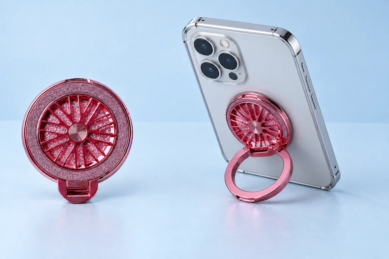 Pink glitter radial-spinner phone ring stand, complete closed product left and original outer ring supporting a phone right on pale blue; phone not included.