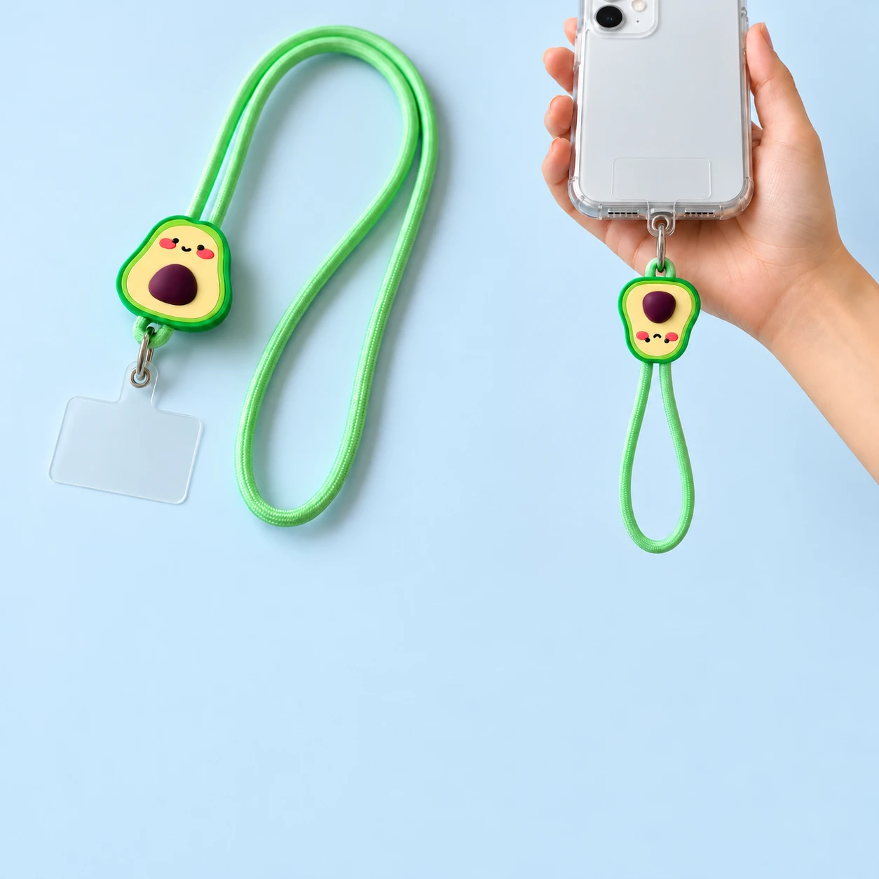 Smiling avocado phone lanyard shown complete with clear case tab and attached to a hand-held phone case, square composition