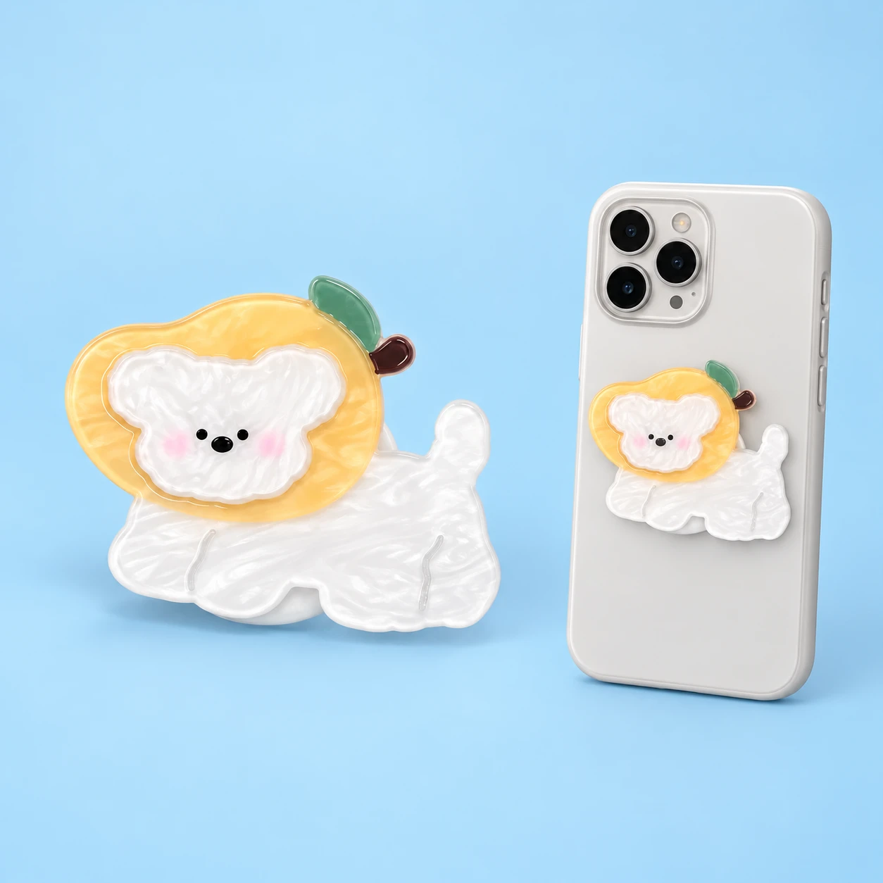 Yellow fruit-hood puppy phone grip with a closed phone-case mounting illustration, square composition
