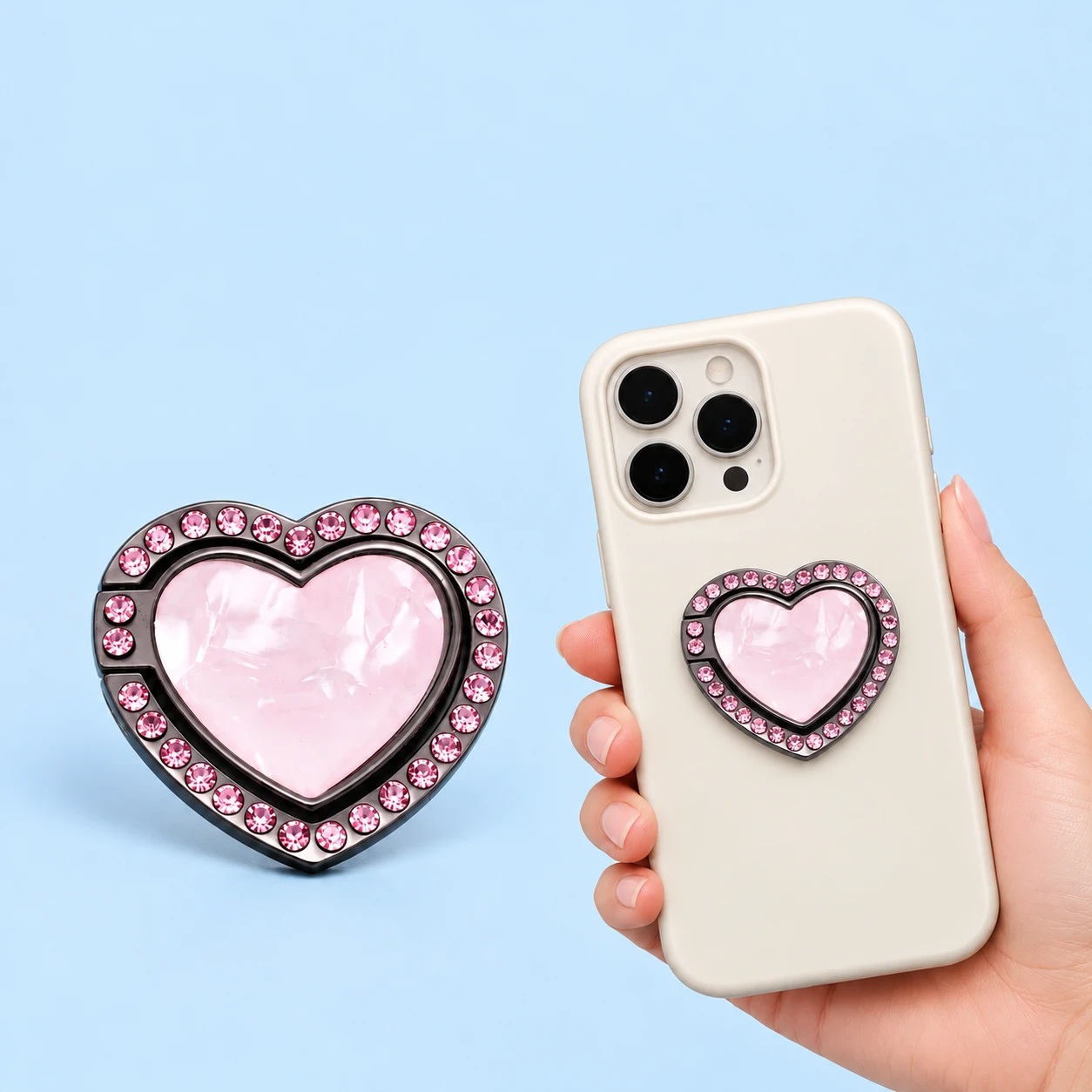 Pink jeweled heart-frame phone ring shown closed alone and mounted on a phone case, square composition