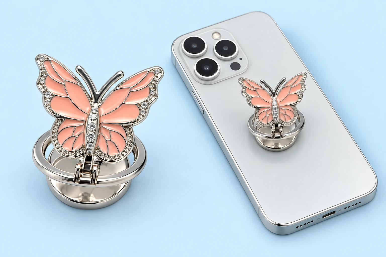 Peach pink segmented butterfly folding phone ring holder shown complete and mounted on a phone