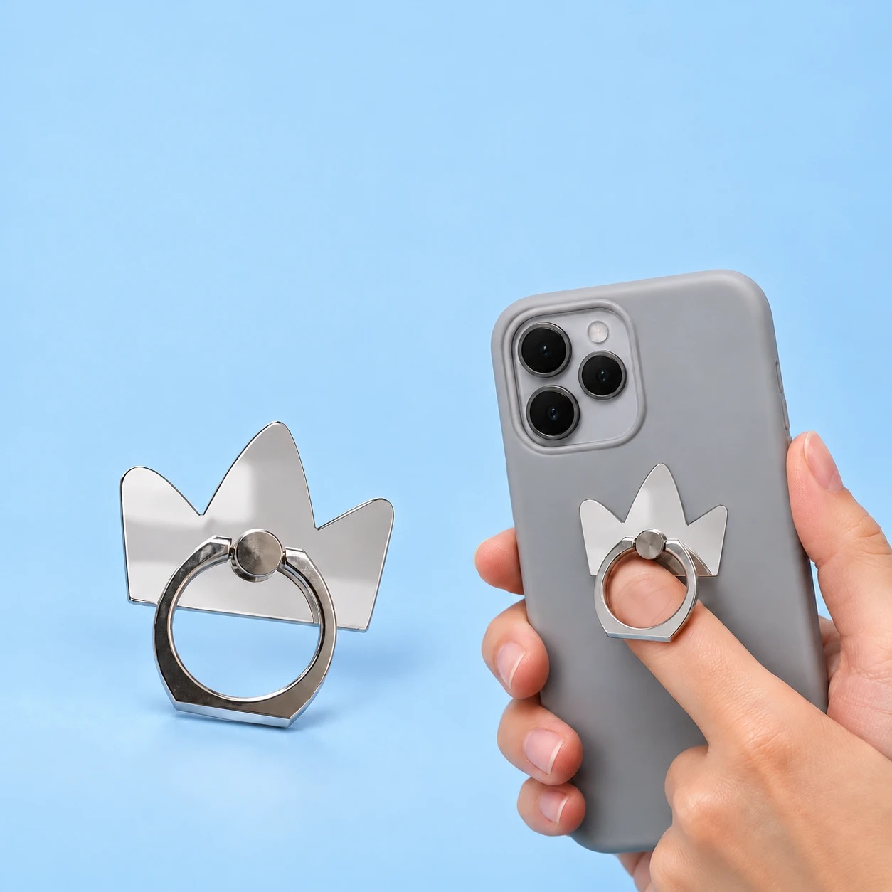 Mirrored three-point crown phone ring holder and illustrative finger-loop use, square composition