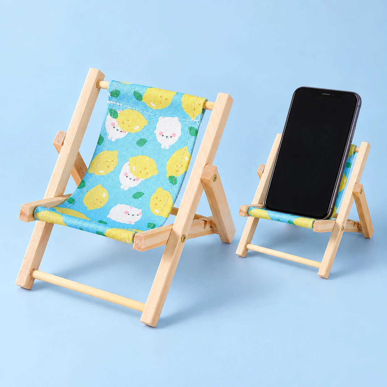 Lemon-Print Mini Wooden Deckchair Phone Stand on a pale-blue background, product left and actual use right