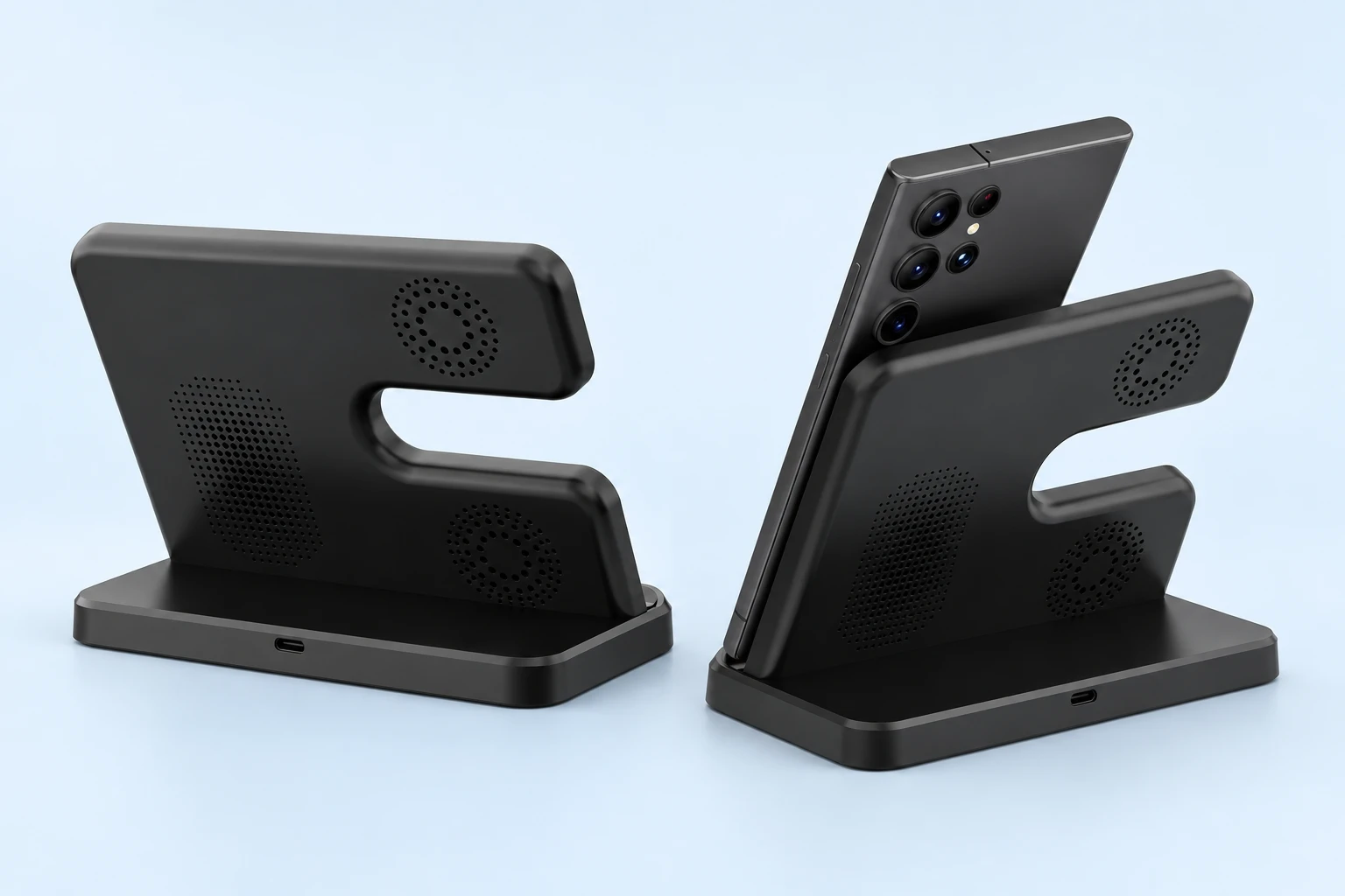 Complete black E-frame charging phone stand shown from the rear beside faithful stationary phone-support use on pale blue. Phone is a demonstration prop; cable and adapter inclusion are unconfirmed.