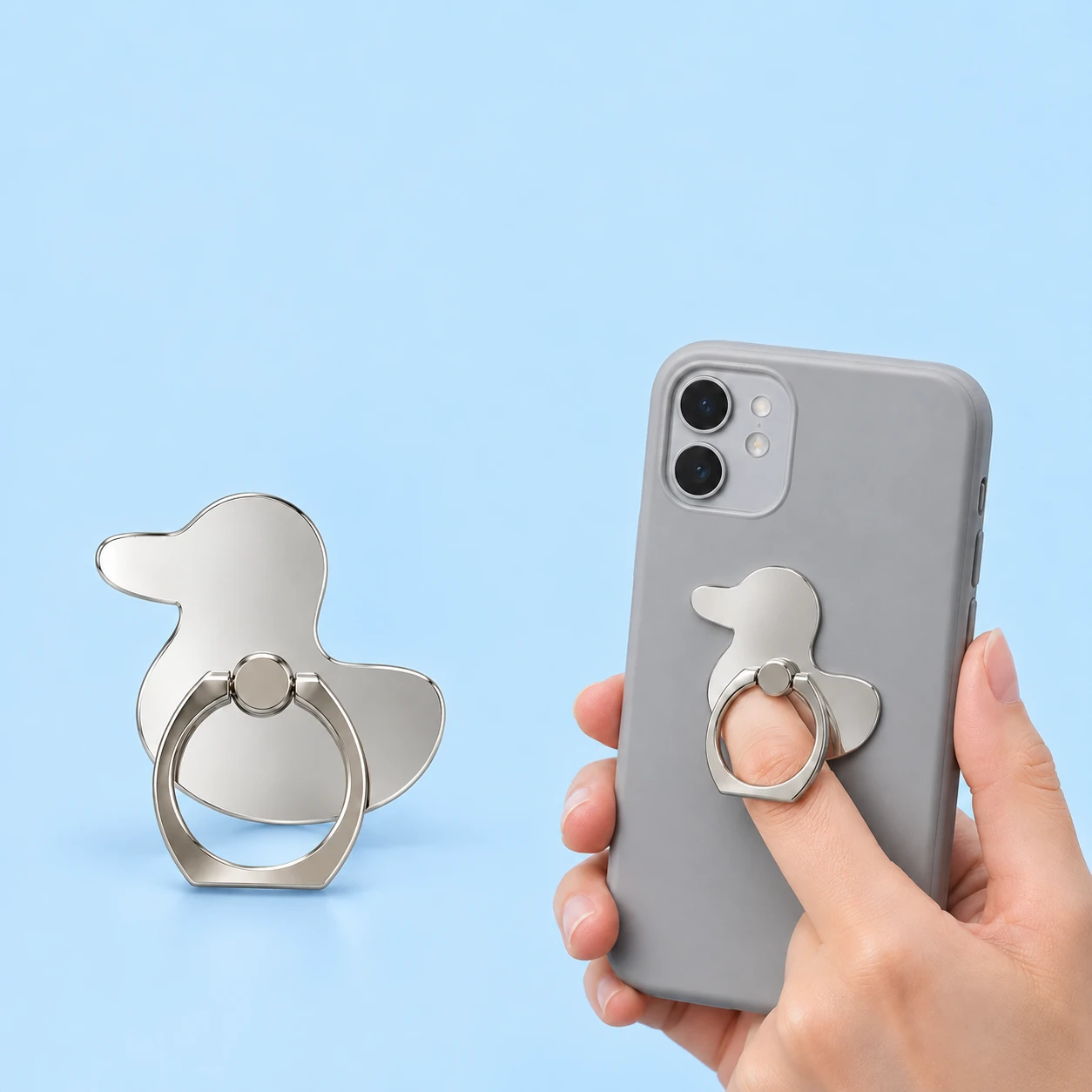Mirrored duck silhouette phone ring holder and illustrative finger-loop use, square composition