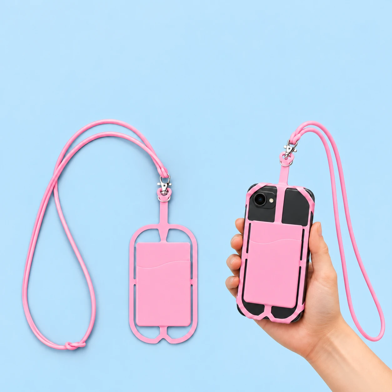 Pink silicone corner-cradle phone lanyard with card pocket shown complete and fitted to a hand-supported phone, square composition