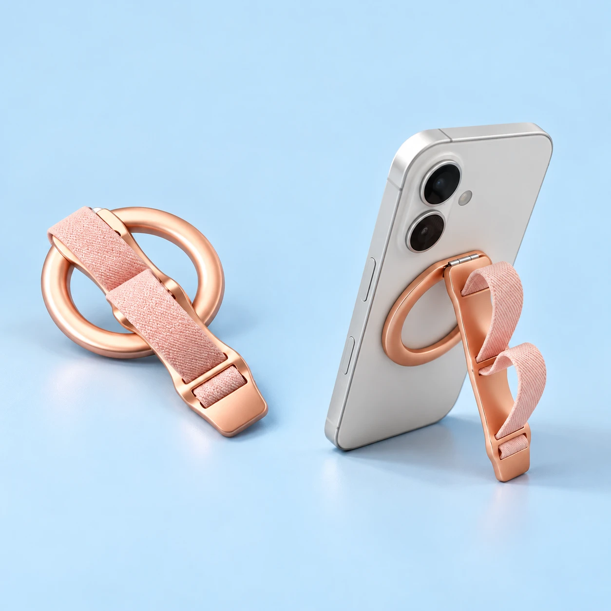 Pink magnetic phone grip with two woven loops and hinged bar, illustrated in portrait stand use, square composition