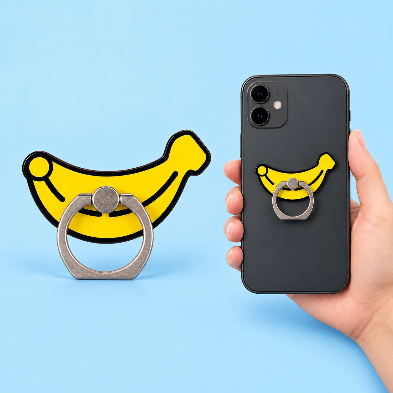 Yellow banana-shaped acrylic phone ring holder shown complete at left and attached to a phone back at right on pale blue; phone not included, square composition