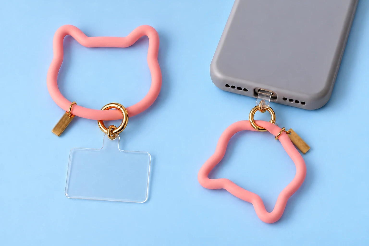 Pastel pink cat-outline silicone phone lanyard with clear tab and spring clasp, complete set and case attachment
