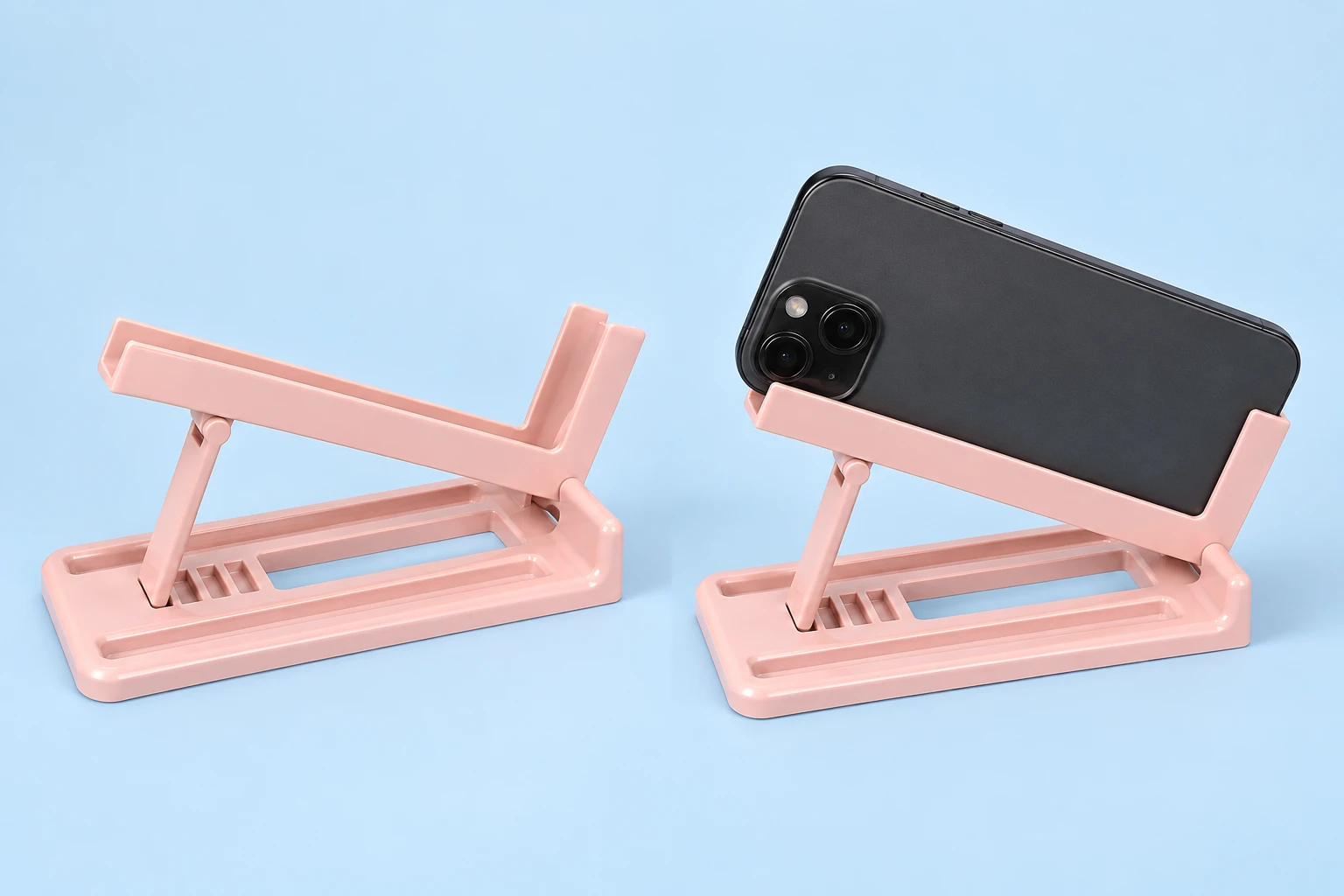 Pastel pink side-tilting rail phone stand with notched base and supported landscape phone