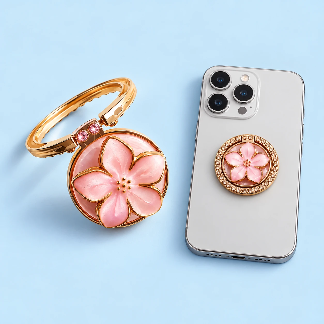 Pink raised five-petal flower phone ring with edge hinge and decorative stone border, shown open and closed on phone, square composition