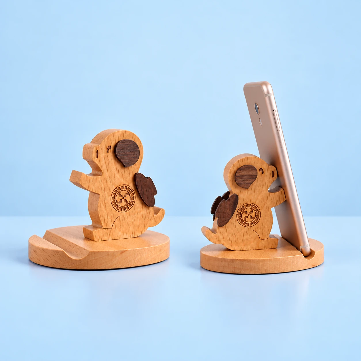 Seated winged pig wooden phone stand with grooved oval base and illustrative portrait-phone use, square composition
