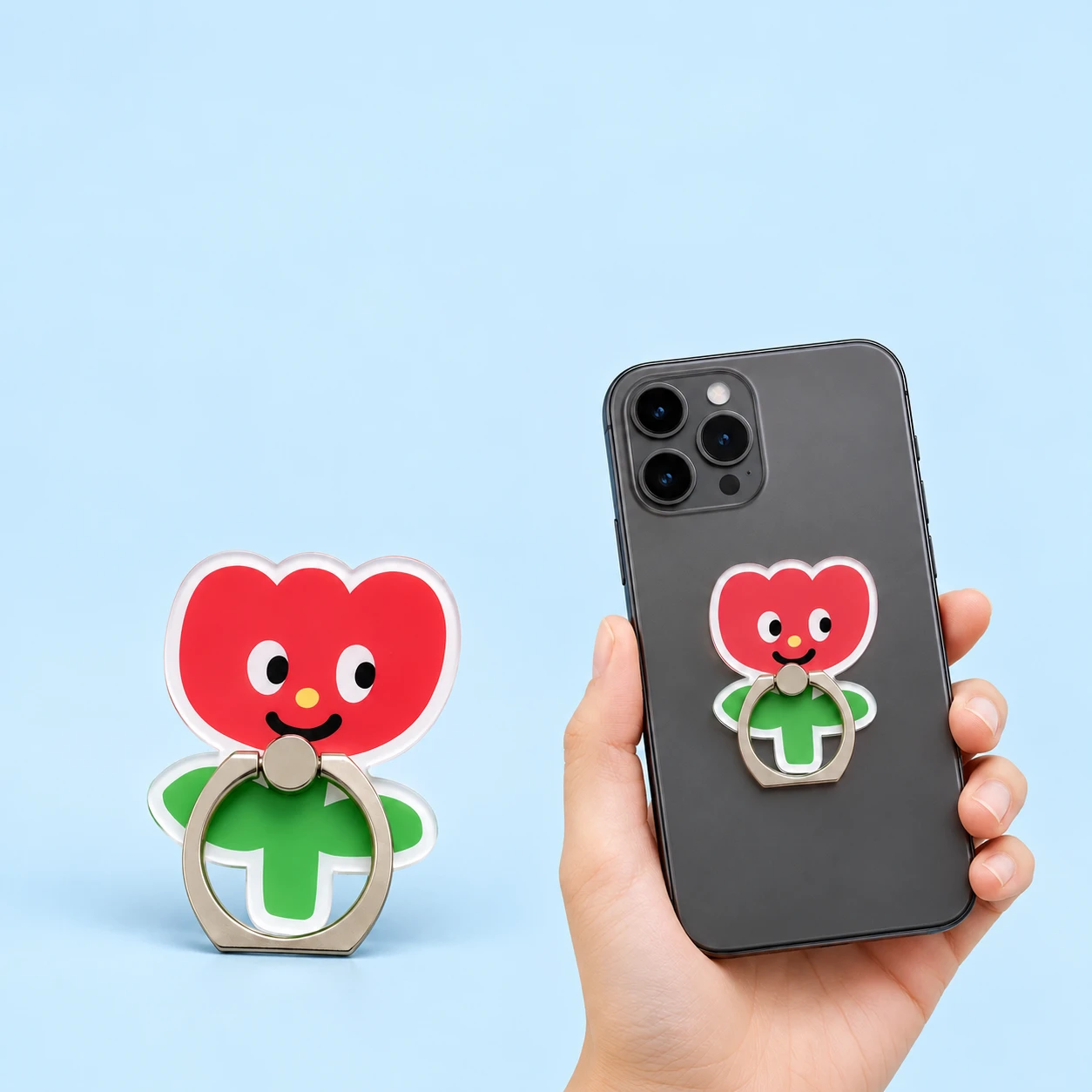 Red smiling flower cutout phone ring holder and illustrative closed placement on a phone, square composition