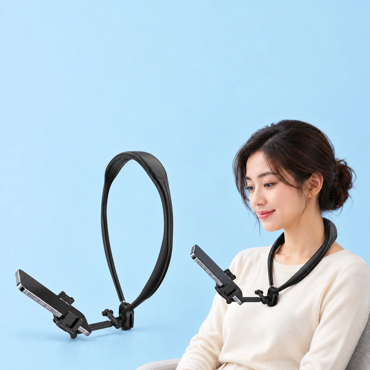 Complete black G02 molded-band neck phone holder with its original compact hinge, straight support link and clamp holding a plain demonstration phone at left; the same holder worn by a stationary seated adult at right, on pale blue. Phone is not included., square composition