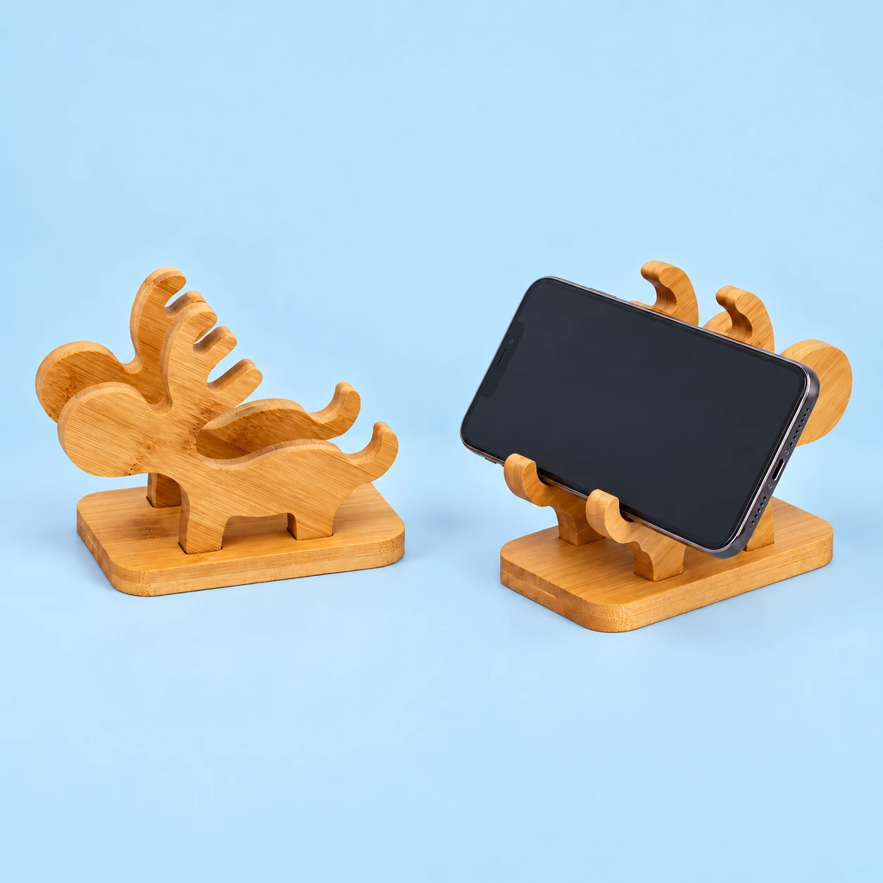 Natural bamboo stand with two parallel deer-antler boards shown complete and supporting an illustrative landscape phone, square composition