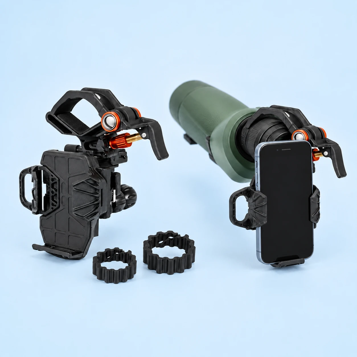 Complete black ribbed-backplate eyepiece phone adapter with orange pivot and two corrugated ring inserts at left; the same adapter retaining a demonstration phone on a spotting-scope eyepiece at right on pale blue. Phone and optical instrument not included., square composition