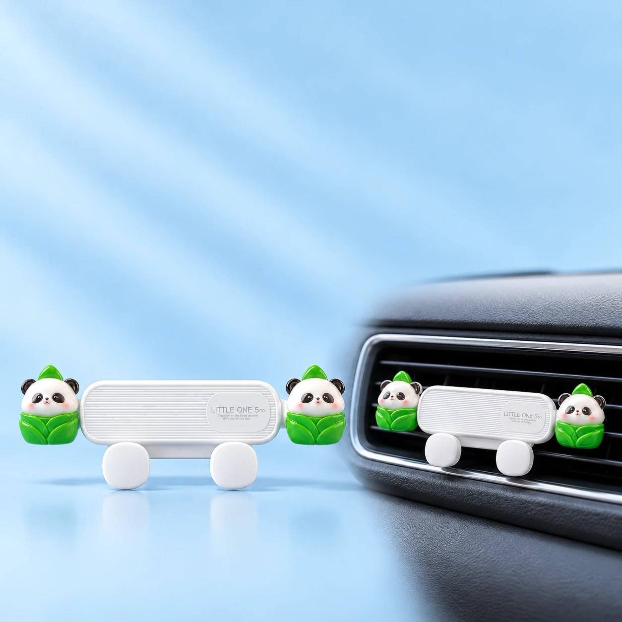 White car vent phone holder with two leaf-wrapped panda decorations shown complete and installed empty, square composition