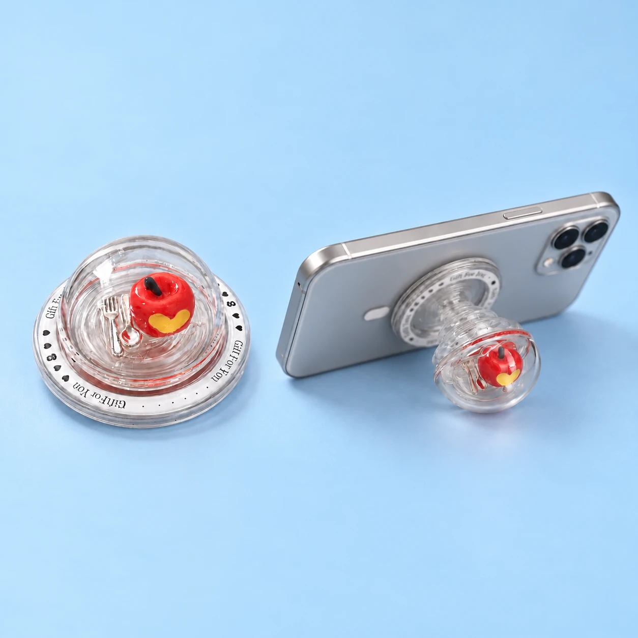 Clear apple-dome magnetic expandable phone grip and source-matched landscape phone support, square composition