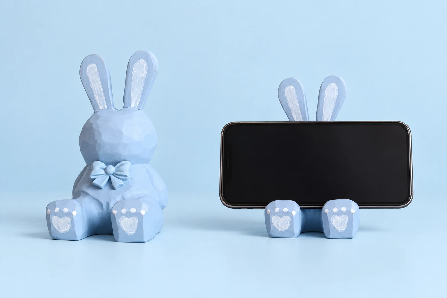 Pastel blue carved wooden rabbit phone stand and illustrative landscape-phone support