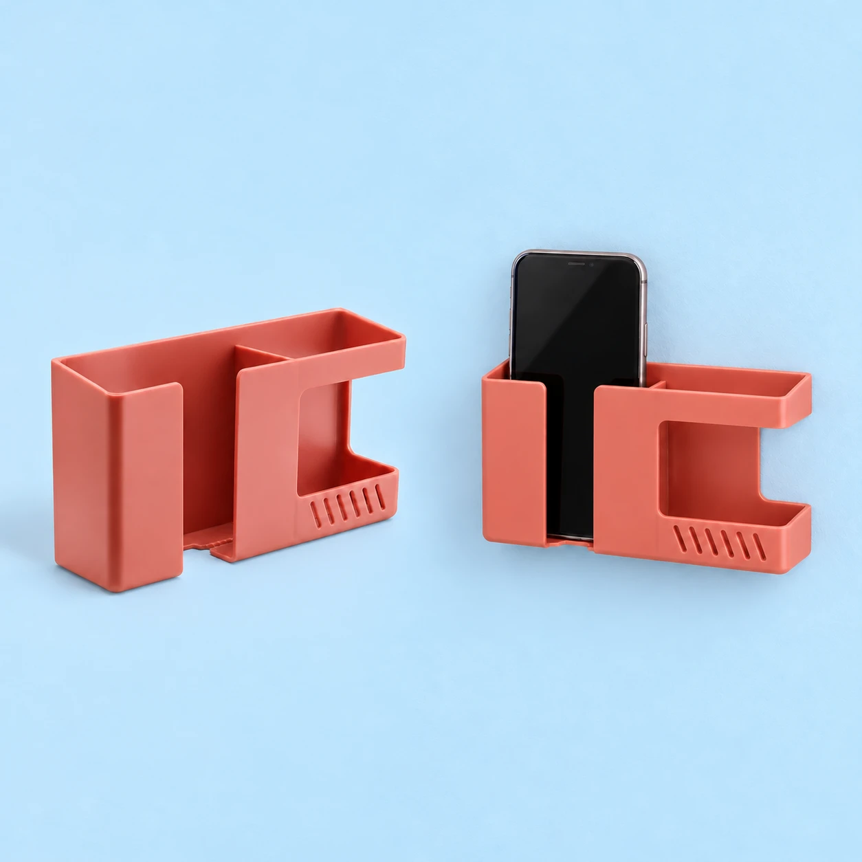 Coral dual-compartment wall phone pocket with side-open C window and six diagonal slots, isolated and in wall use, square composition