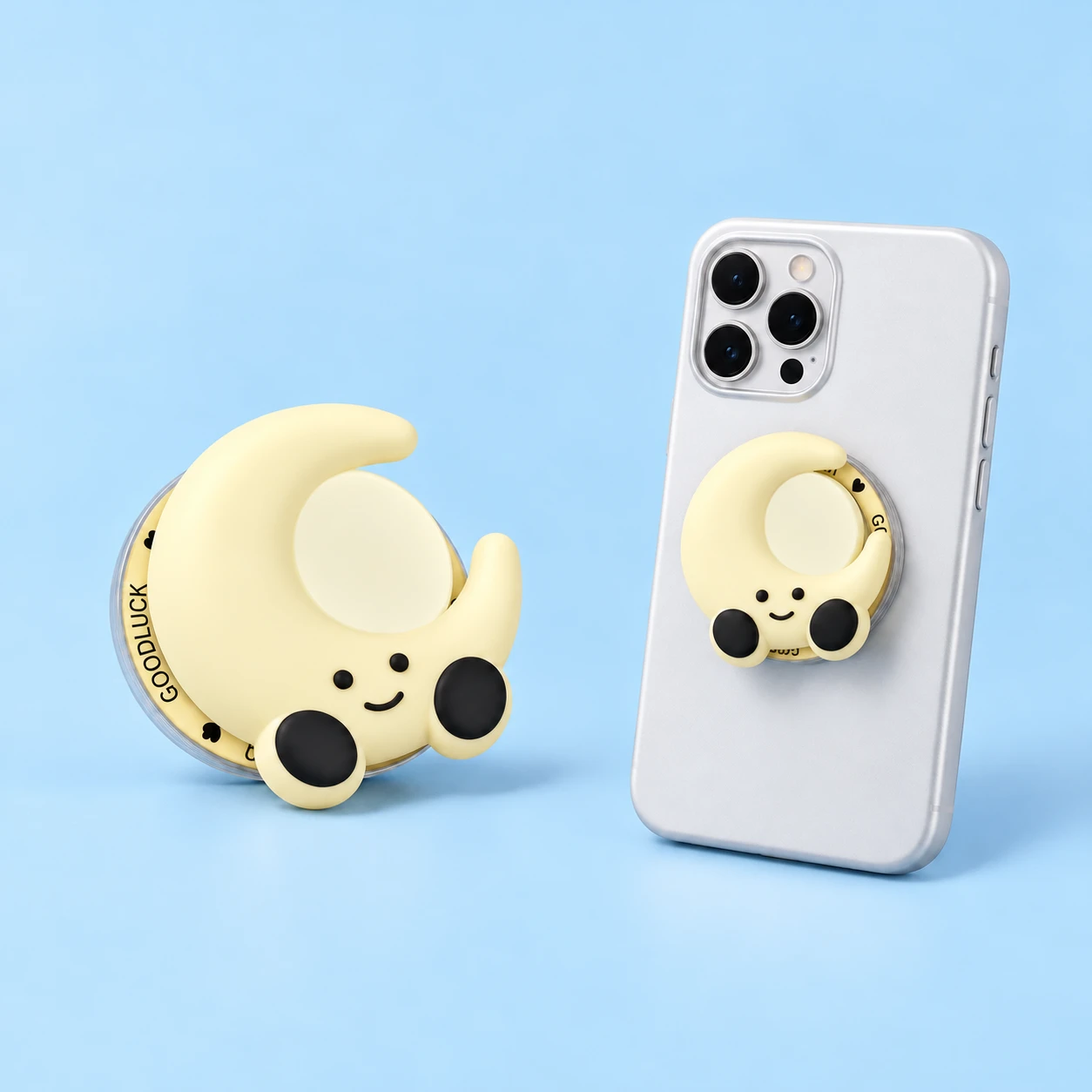Cream smiling crescent moon magnetic phone grip with printed ring and closed mounting illustration, square composition