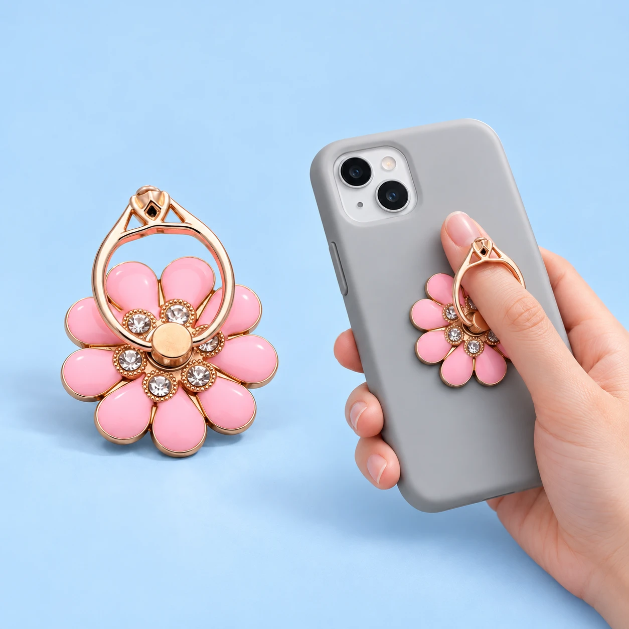 Pink nine-petal flower phone ring holder with decorative jewel accents and illustrated finger-loop use, square composition