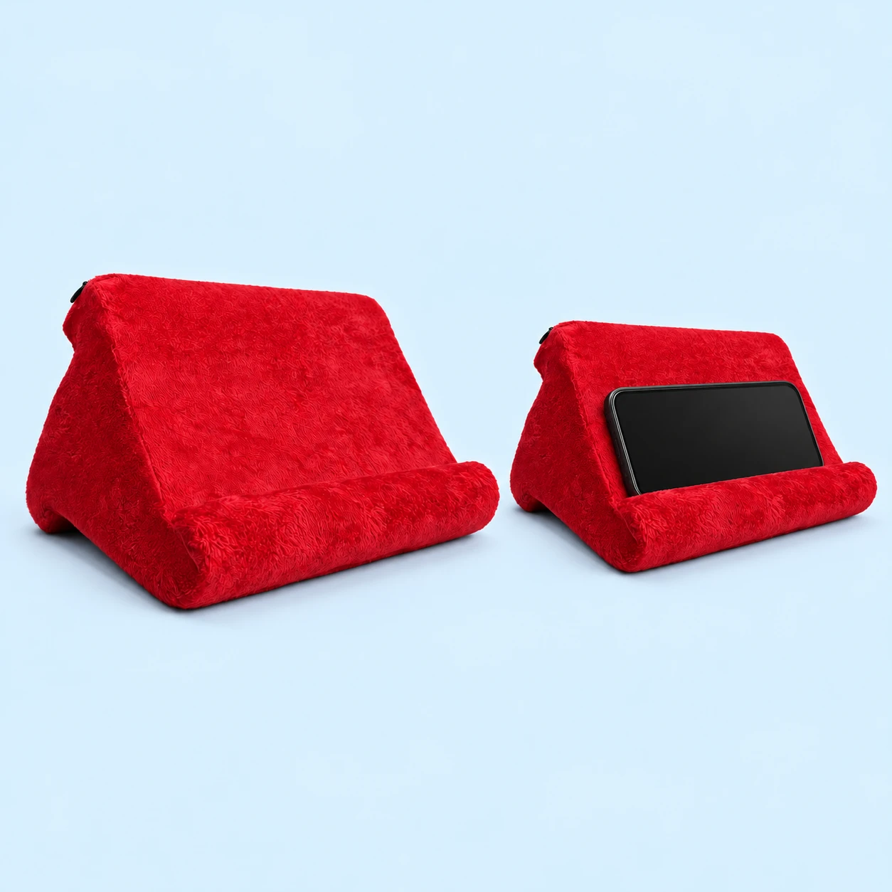 Complete red cloth-covered three-lobed foam phone cushion without a pocket, beside an intended landscape-phone use illustration behind the original retaining roll on pale blue; phone not included., square composition