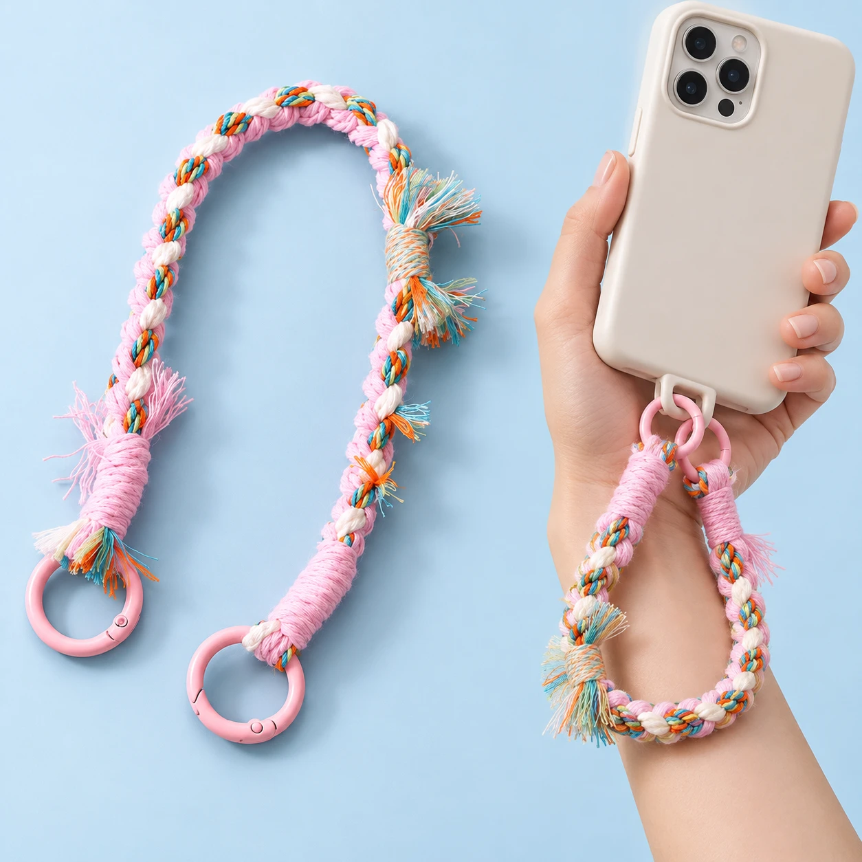 Pink and cream tassel-braid phone wrist strap with two original pink gates, shown complete and in intended hand-supported compatible-case use.