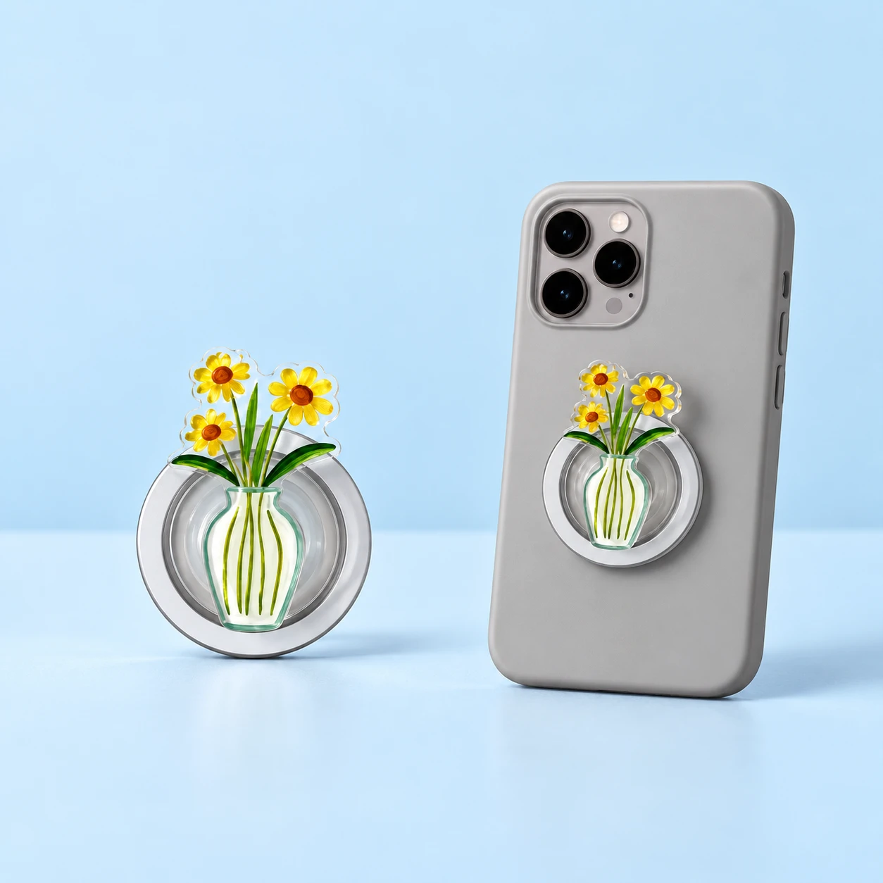 Three yellow flowers in a striped vase magnetic expandable phone grip shown closed on a phone, square composition