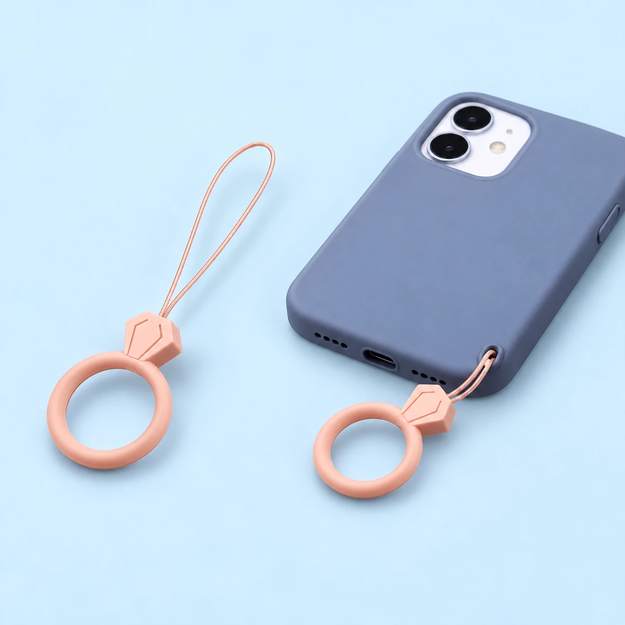 Sand pink gem-top finger-loop phone lanyard shown alone and attached through a phone-case eyelet, square composition