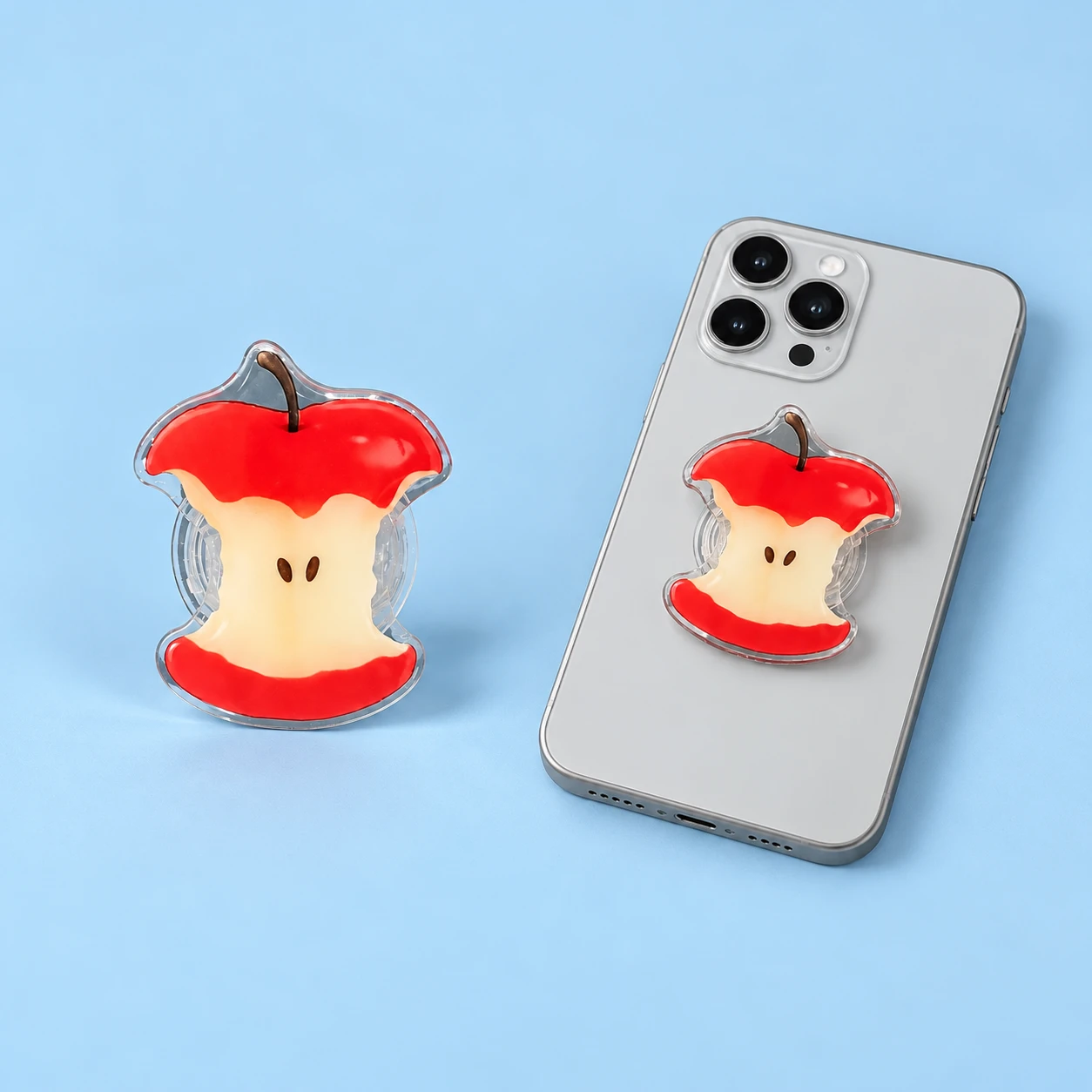 Red apple-core expandable phone grip, collapsed product and closed phone-back mounting illustration, square composition
