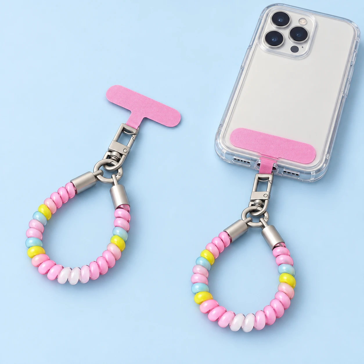 Pastel pink blue and yellow coil phone wrist loop with pink anchor, product and supported compatible-case use