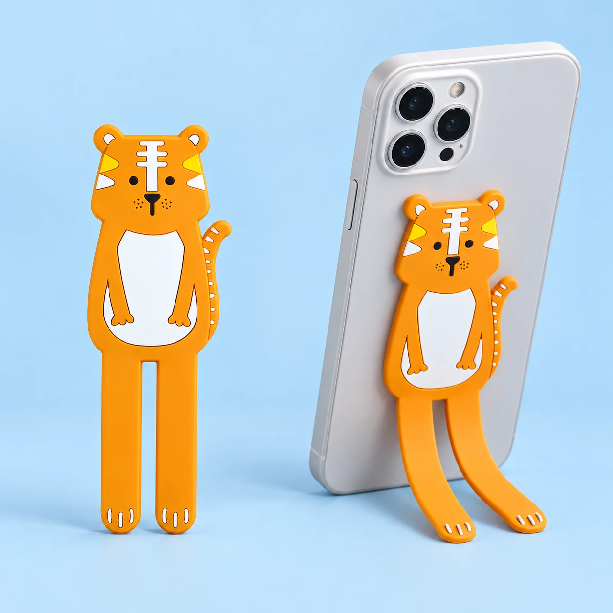 Orange Tiger Bendable Phone Kickstand, complete product on left and portrait phone support on right on pale blue; phone not included