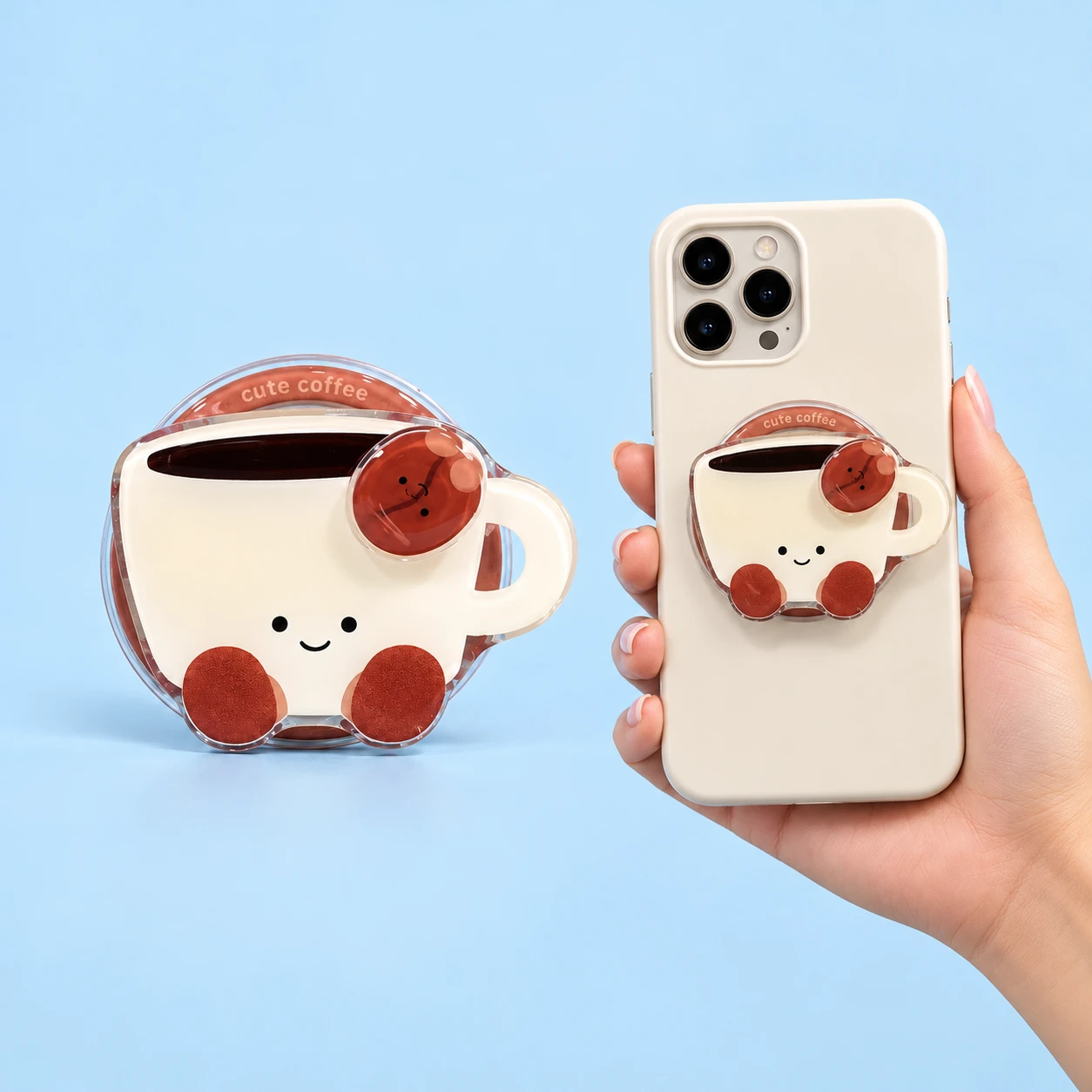 Smiling cream coffee-cup phone grip with brown bean detail, shown complete and mounted flat, square composition