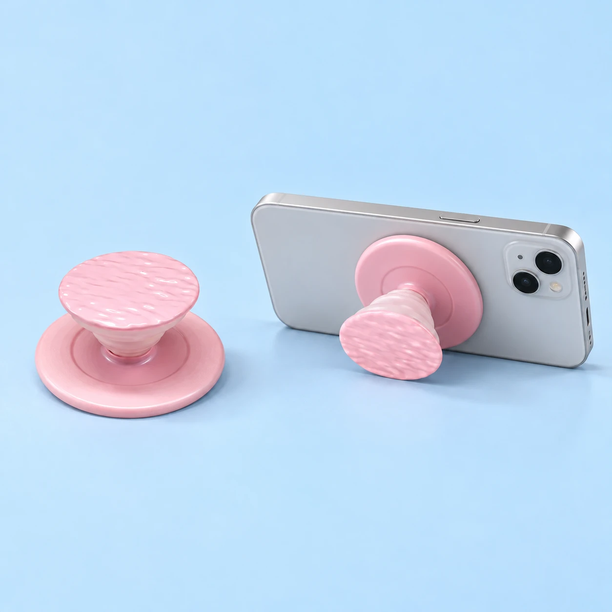 Pastel pink ripple-face magnetic expandable phone grip with illustrated landscape support, square composition