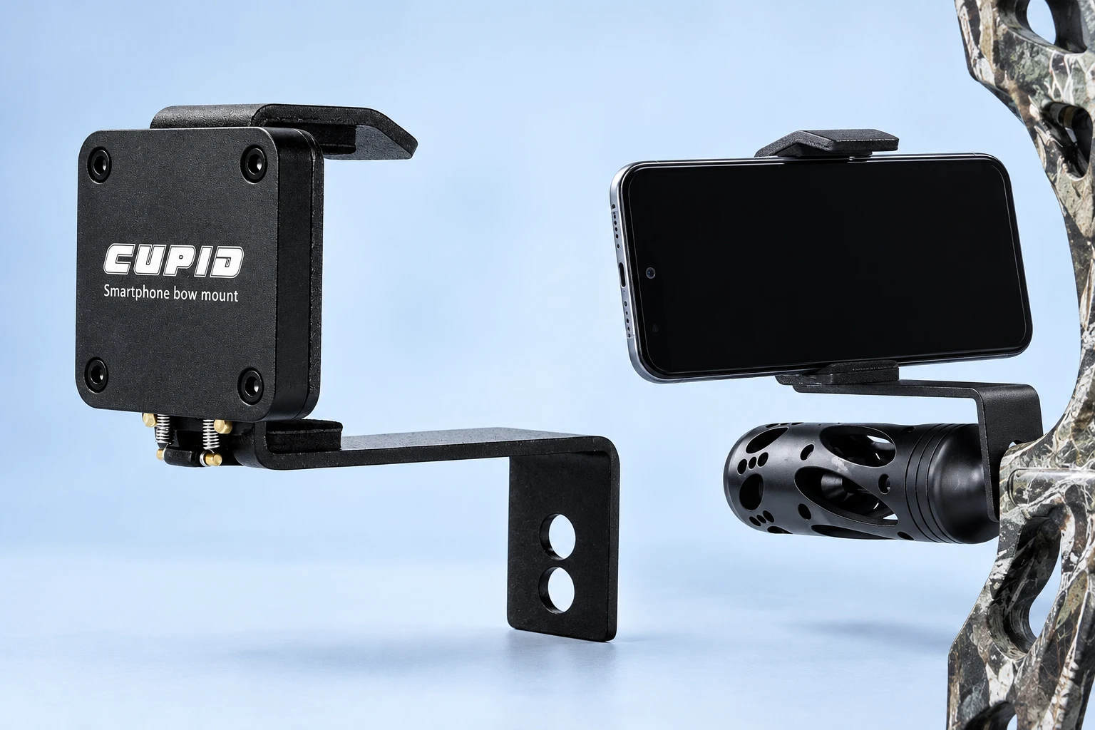 Complete black twin-spring phone mount with its original bent two-hole arm on the left; a horizontal demonstration phone held by the same mount on stationary cropped archery equipment at right, against pale blue. Phone and host equipment not included.