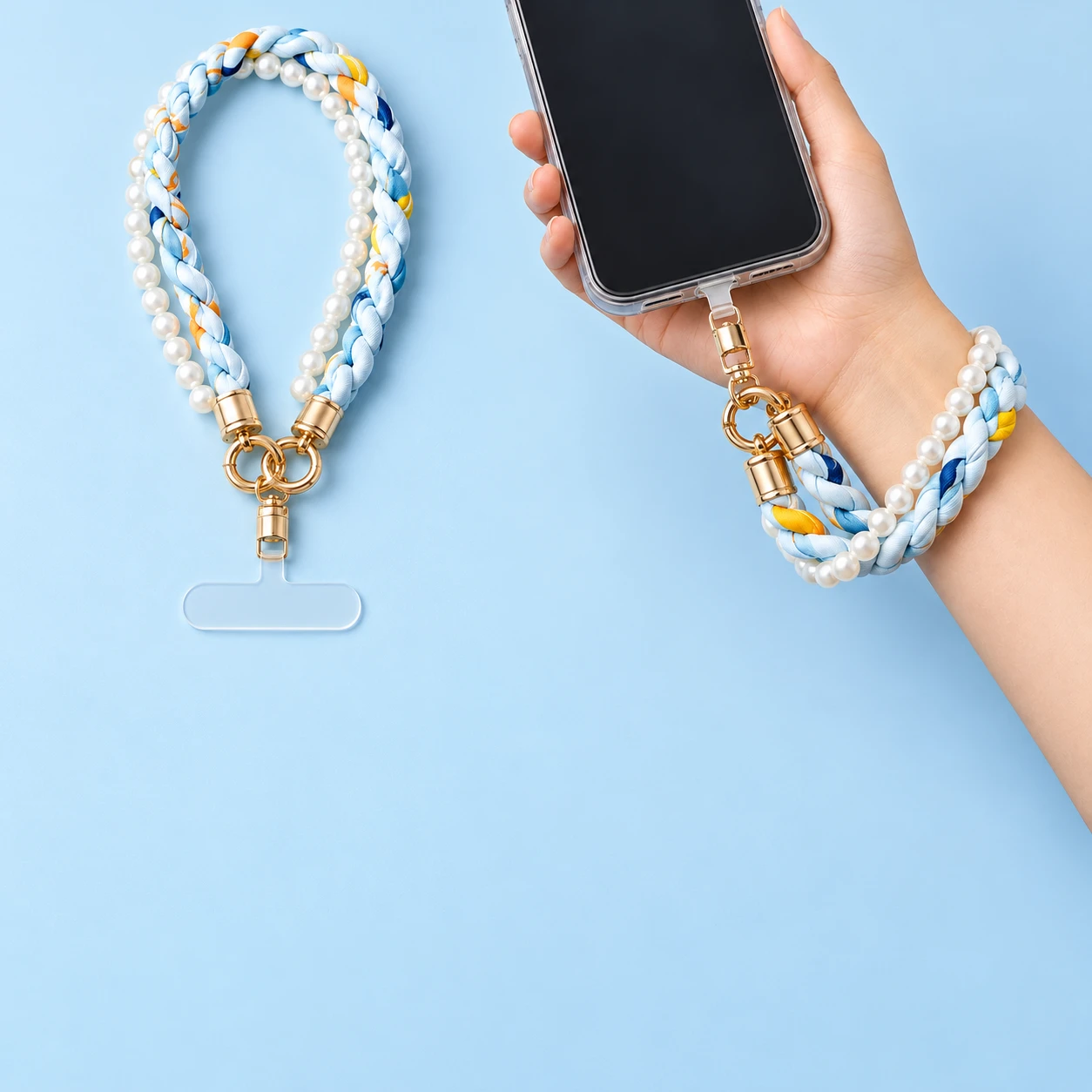 Sky-blue fabric braid and pearl-effect wrist phone lanyard with clear case tab and hand-supported use, square composition