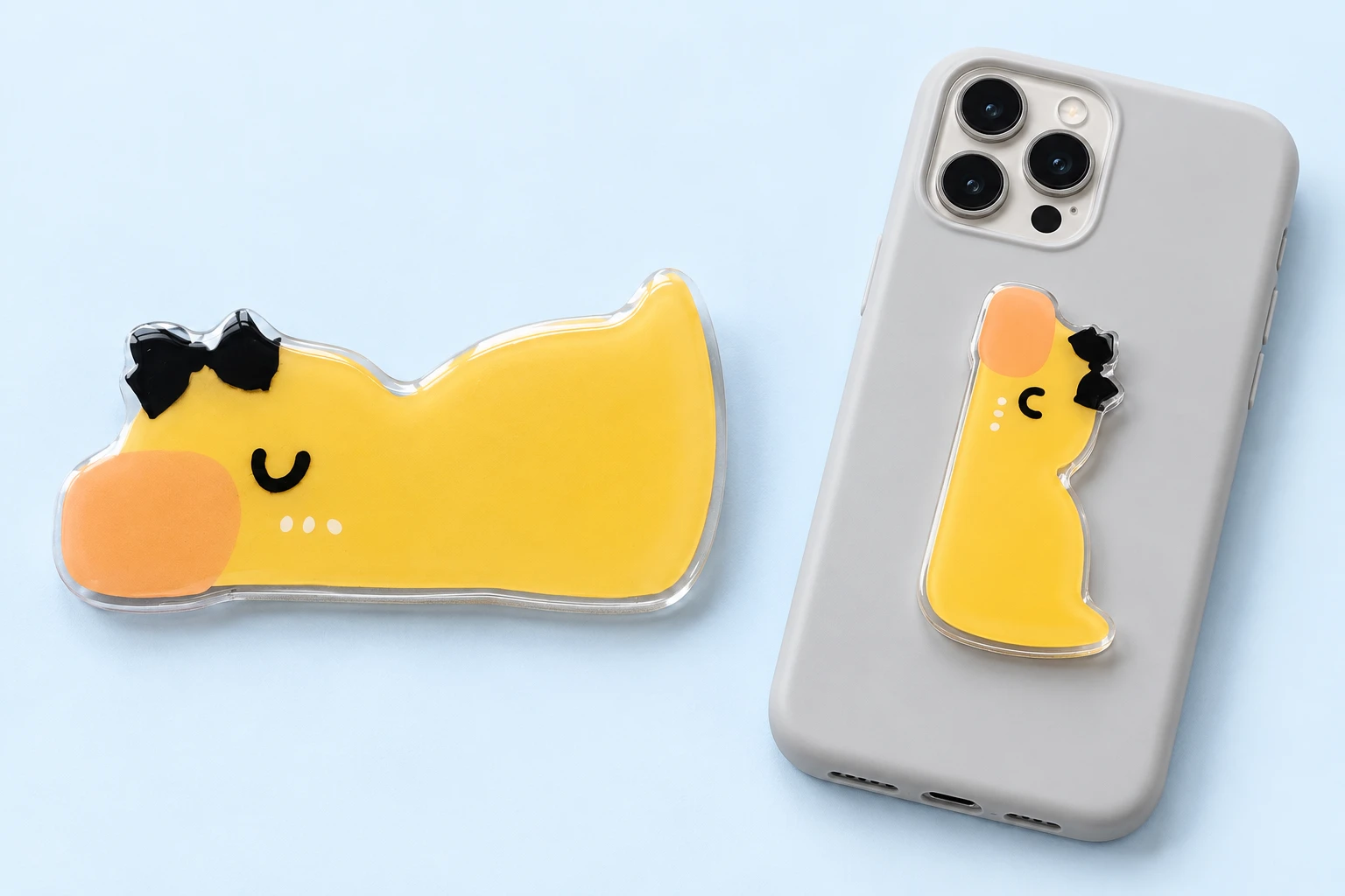 Yellow duck-shaped folding phone kickstand with black bow and closed phone-back placement