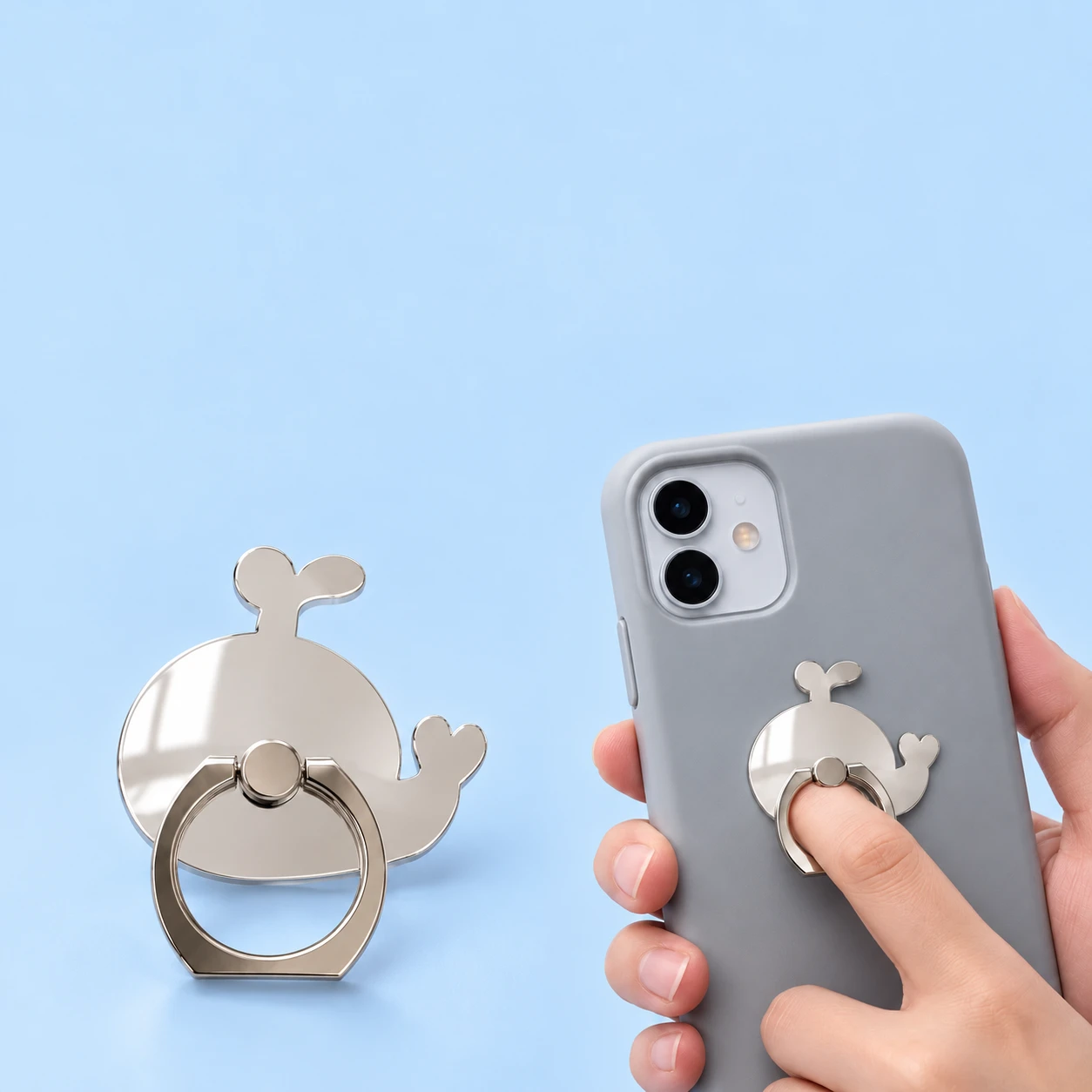 Mirrored whale phone ring holder, complete product and illustrative finger-loop use, square composition